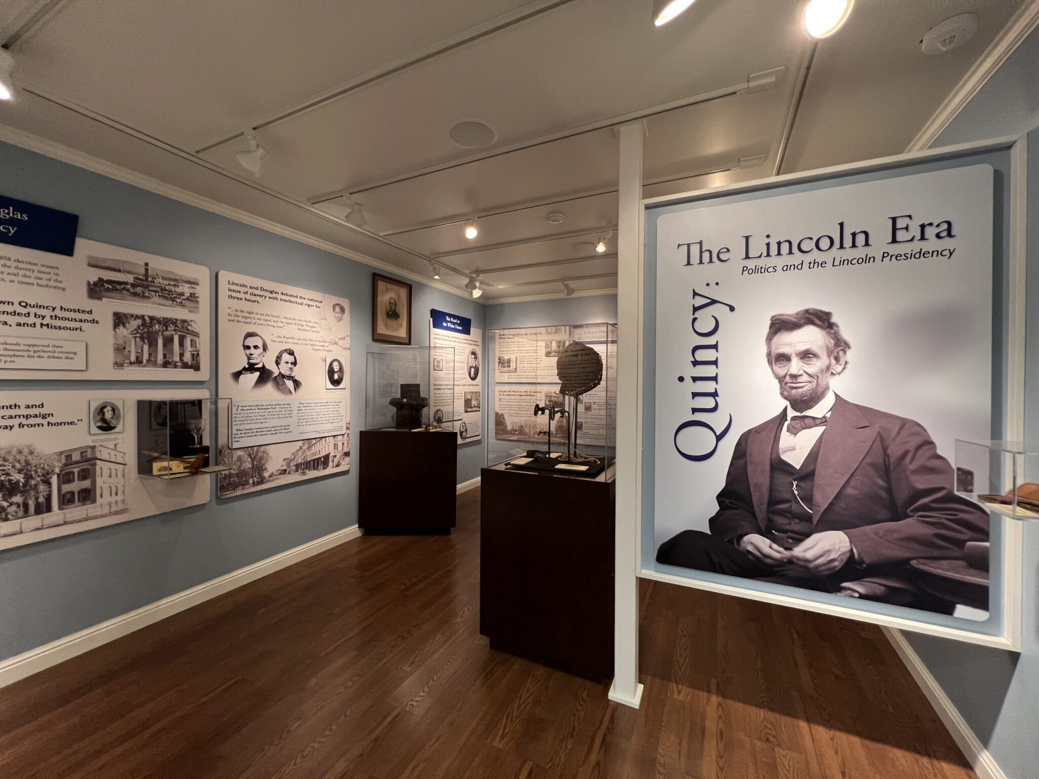 The entrance to the Lincoln Gallery, showing a large photo of Abraham Lincoln with exhibits in the background.