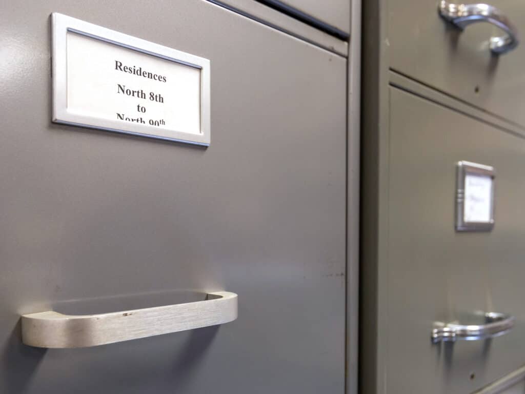 A gray and a green filing cabinet next to each other, with the tag "Residences North 8th to North 90th"