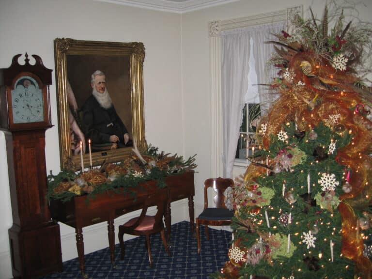 Colored photo of the interior of the John Wood Mansion at Christmas time.